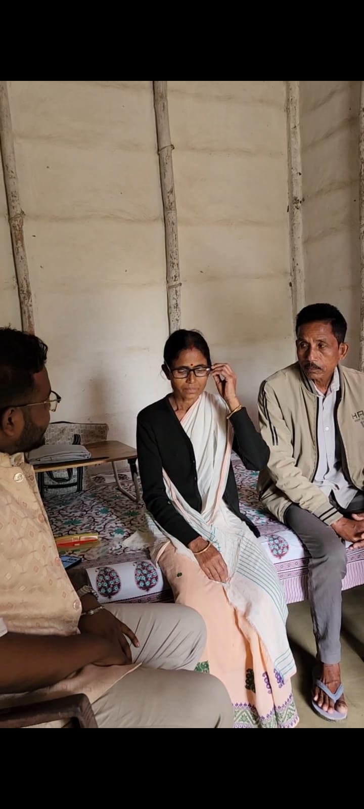 Beneficiary trying her new glasses during a home visit