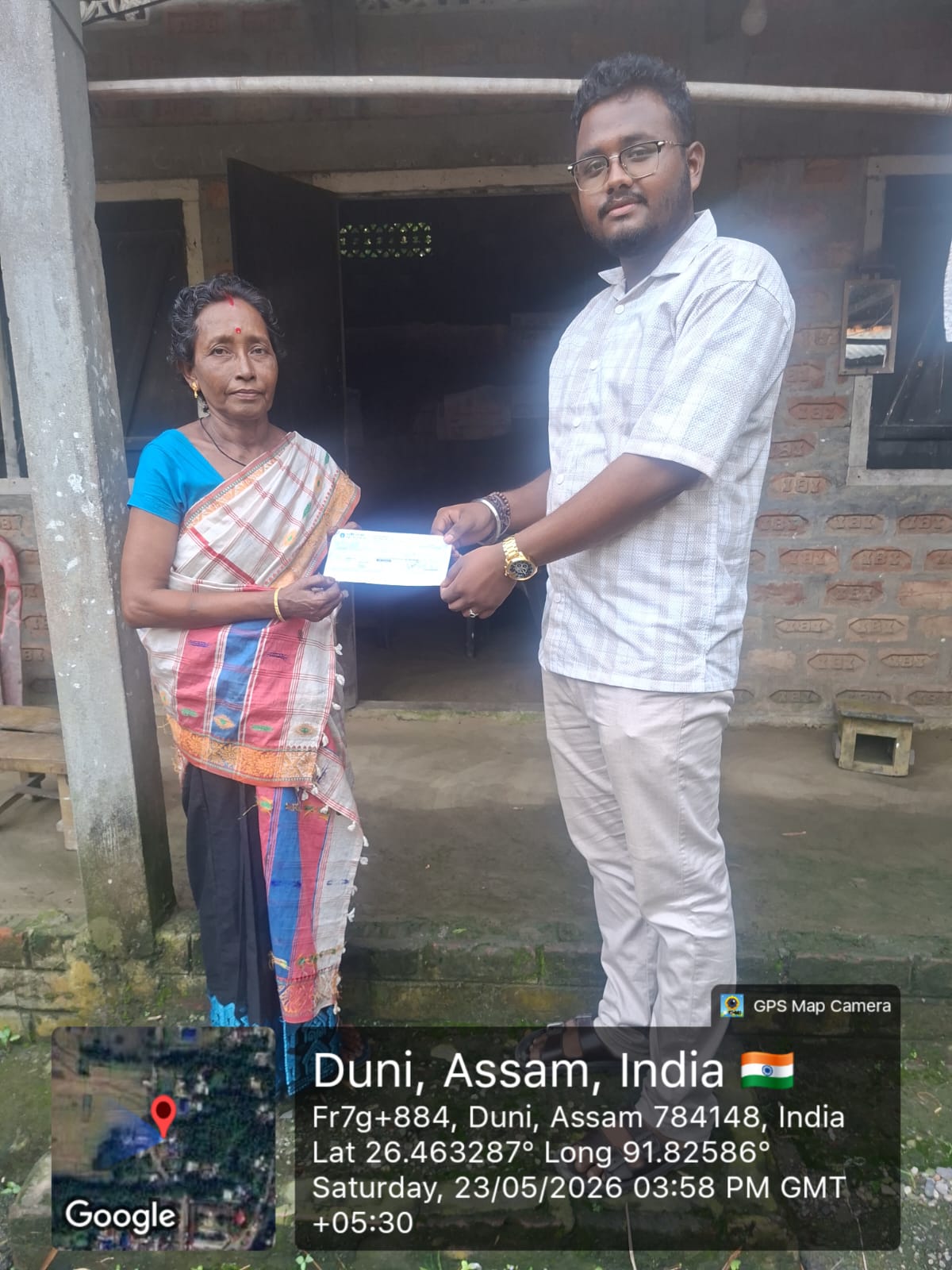 Cheque handover to a beneficiary at Duni, Assam — 23 May 2026
