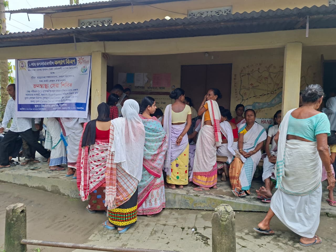 Community members waiting outside the camp venue