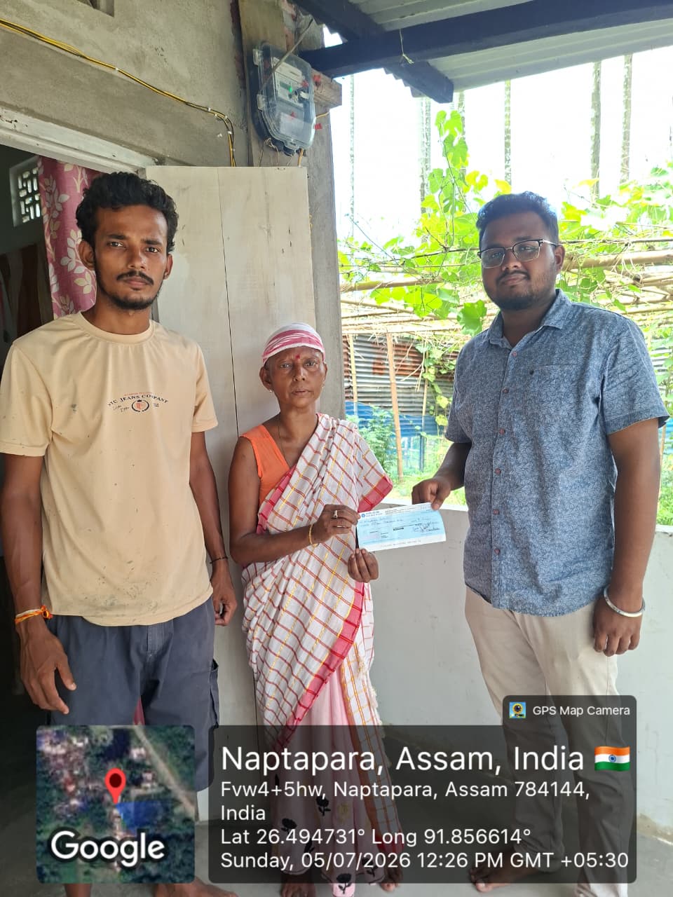 Cheque handover to a beneficiary and family at Naptapara, Assam — 5 July 2026